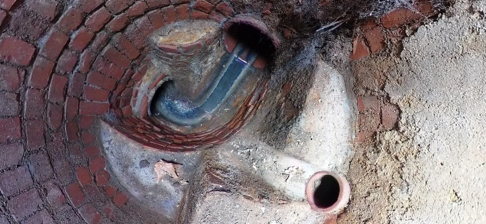 Interior sewer manhole view showing flow channel where monitoring equipment may be installed